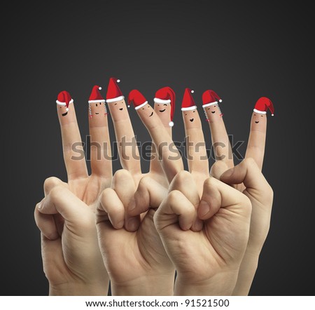 Fingers dressed in Santa-Claus red-white hats. Group of happy finger smileys  representing a social network. On a black background.