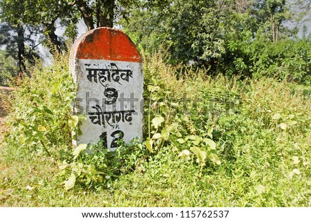 Milestone indicating 9 kilometers to Mahadev. Shot location Pachmarhi, Madhya Pradesh, India