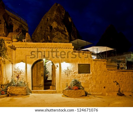Limestone cave residence converted to a boutique hotel Goreme, Turkey. Night scene under street lights, horizontal landscape with negative area and empty space