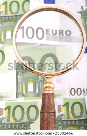 object on white - currency magnifying glass with money