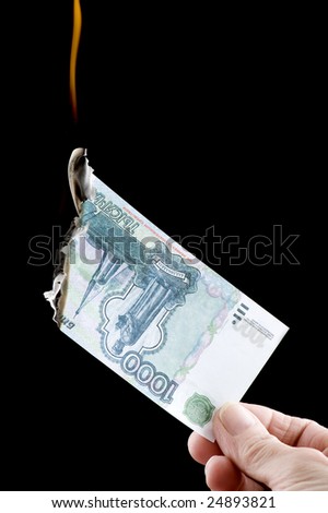 object on black - currency burning paper money