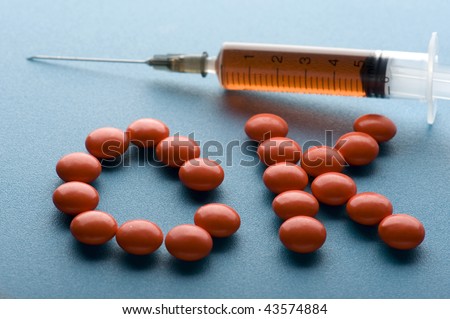 object on blue- Medical Tablet and syringe close up