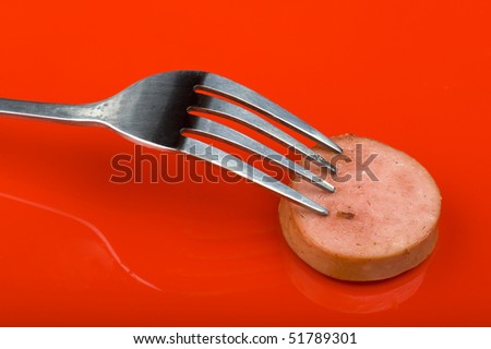 object on red - food frankfurter with ketchup and mustard