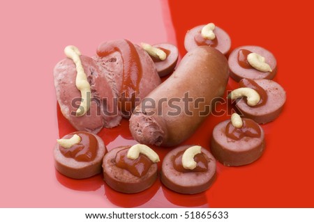 object on red - food sausage with ketchup and mustard
