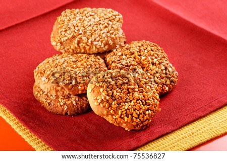 object on red - cookies with sesame seeds