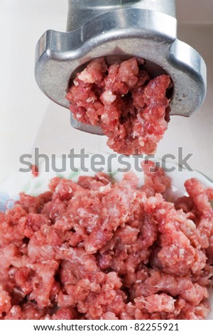 object on white - meat grinder with mince meat