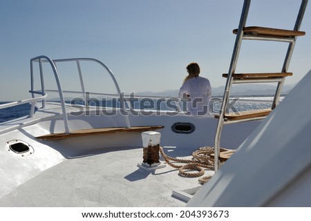 Girl in white on the yacht deck.