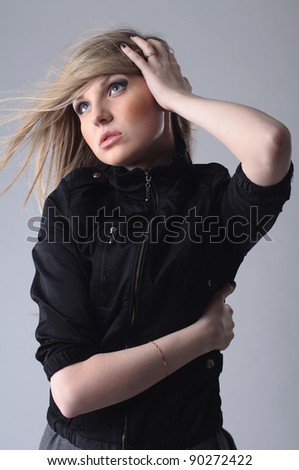 Stylish portrait of beautiful girl with fluttering hair.