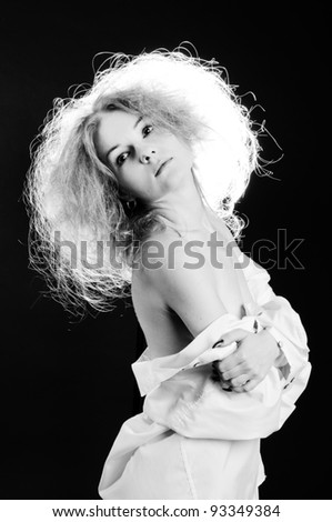 Black and white portrait of sensual woman with fluffy hair.