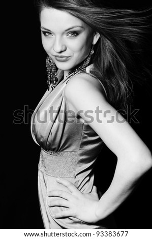 Black and white portrait of luxurious model with fluttering hair.