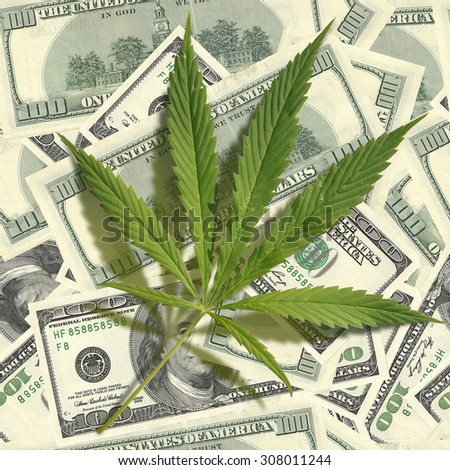 Cannabis leaf on a pile of dollars. Seamless image