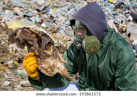 Man in a gas mask looking at animal skeleton
