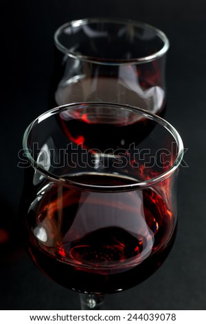 Glass Cups Filled With Red Wine Over Black Background Closeup