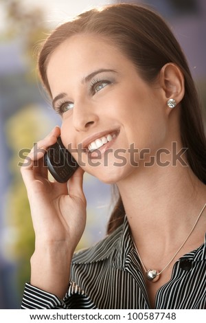 Closeup portrait of happy attractive woman on phone call, smiling.