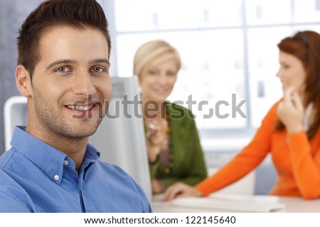 Happy office portrait, smiling businessman and female coworkers.