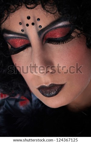 Closeup portrait of woman with professional devil makeup. Eyes closed.
