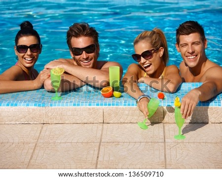 Beautiful Young People Having Fun In Swimming Pool, Drinking Cocktail, Smiling.