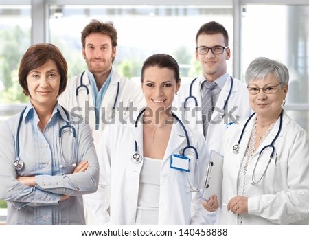 Group of happy doctors in hospital corridor portrait Group of happy doctors in hospital corridor portrait