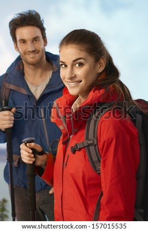 Portrait of young hiker woman smiling at camera.