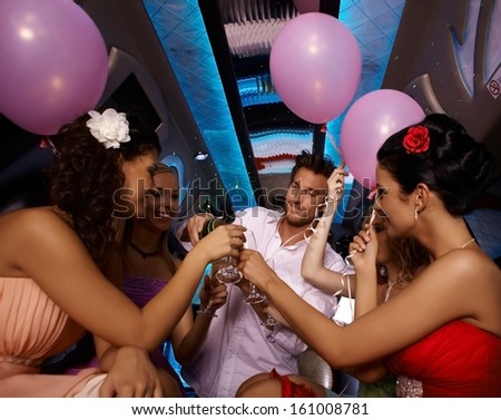 Party time in limo with young females and handsome man.