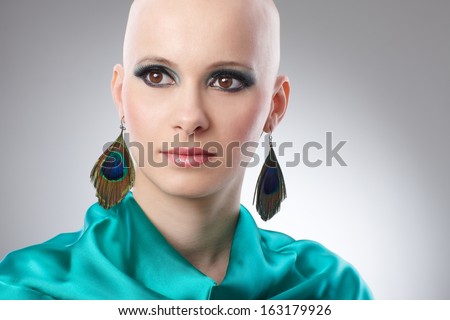 Beauty portrait of bald woman in turquoise silk dress