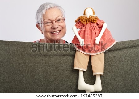 Granny presenting a puppet show, smiling.