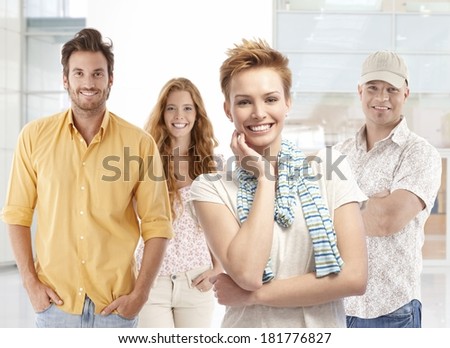 Portrait of happy young men and women, smiling, looking at camera.