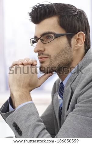 Closeup profile of thinking businessman in glasses.