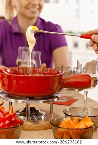 Closeup photo of cheese fondue with melting cheese.
