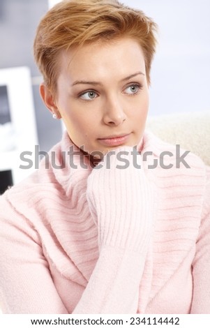 Young woman in pink pullover with angel face.