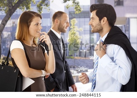 Attractive businesswoman flirting with colleague after meeting on the street.