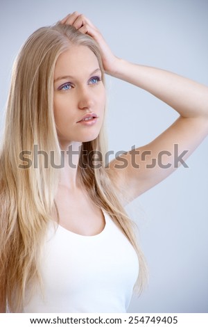 Portrait of nordic type woman looking away with hand in hair.