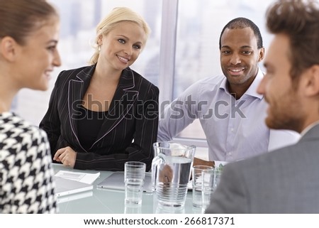 Young partners having businessmeeting, smiling happy.