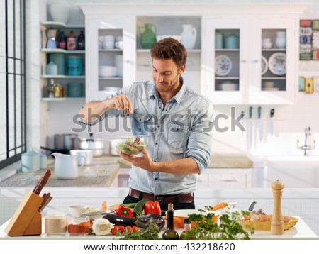 Casual man preparing salad at home in kitchen.