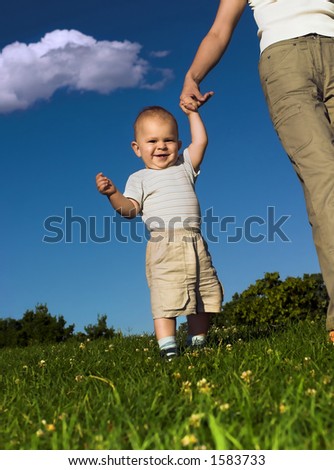 1 Year Old Baby Is Practicing How To Walk While His Mother Give Him A 