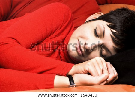 Young woman is sleeping on the couch.