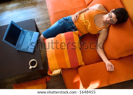 Young women takes a break and sleeps on the couch.