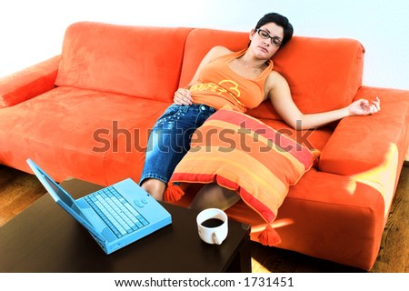 Young women takes a break and sleeps on the couch.