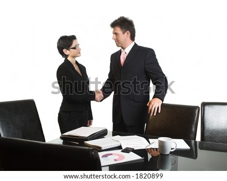 Young business people are shaking hands after a business deal. Isolated version.