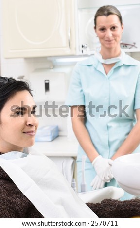 A happy patient and a friendly dentist in the dentist\'s office.