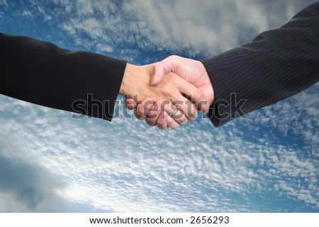 Conceptual image: Man and woman are shaking hands after a business deal.