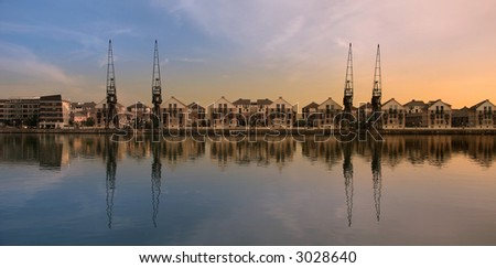 These are cranes in the dock. The location is london on the bank of Thames.