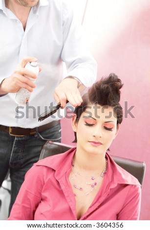 Beautiful young woman gets a hairdo in the beauty-shop.