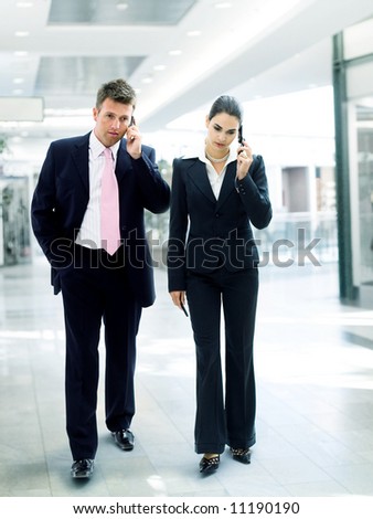 stock photo Busy business people walking and calling on mobile
