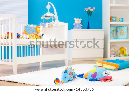 Crib and soft baby toys at children's room. Toys are officially property released.