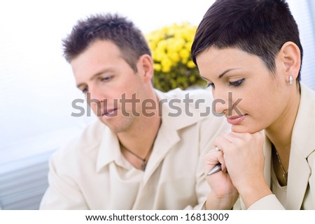 Business couple working at office, thinking.
