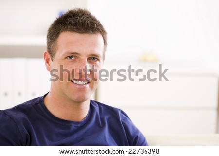 Portrait of casual happy man at home, smiling.