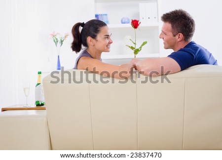 Romantic man giving red rose to woman - Valentine\'s Day.