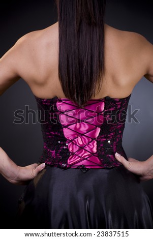 Back side of a birght purple, laced coktail dress with black skirt.