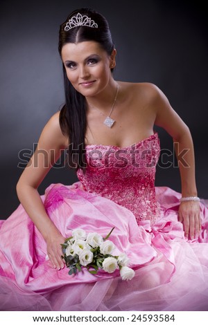 stock photo Smiling young bride posing in a pink wedding dress